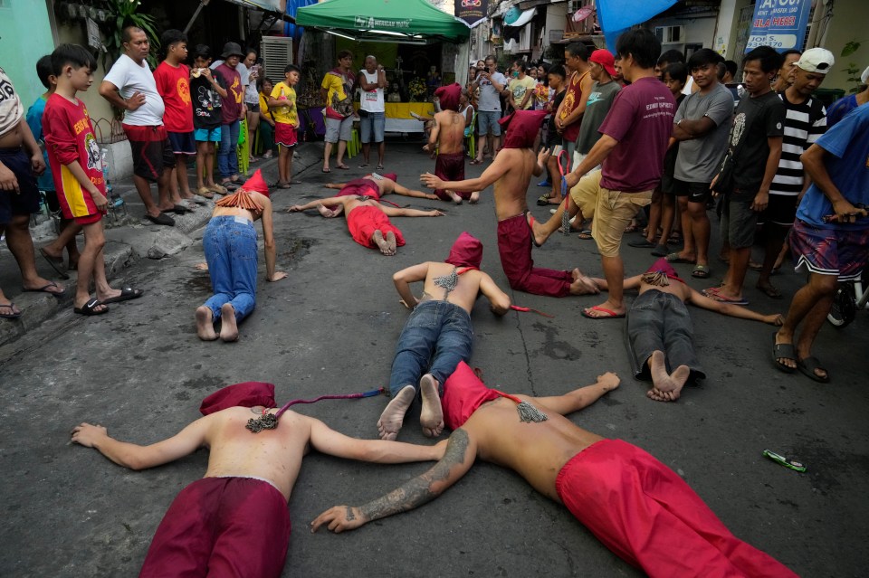 Those taking part in the ritual lying on the ground