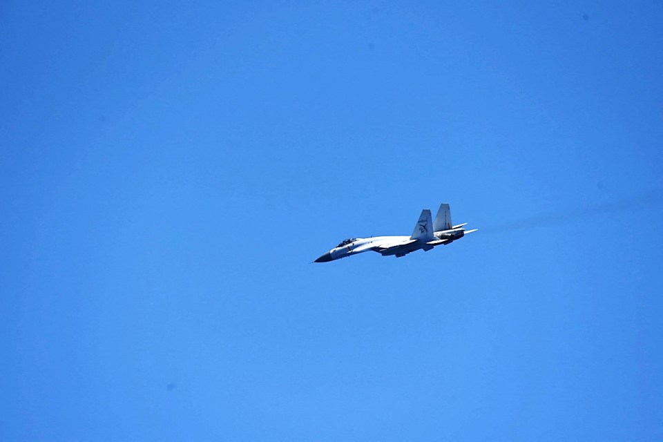 A Chinese Shenyang J-15 fighter aircraft flies near China's Shandong aircraft carrier on April 15