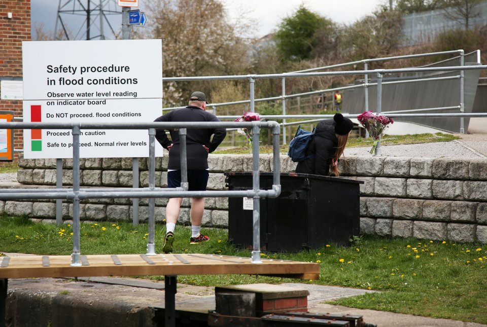 Members of the public viewing flowers and notes