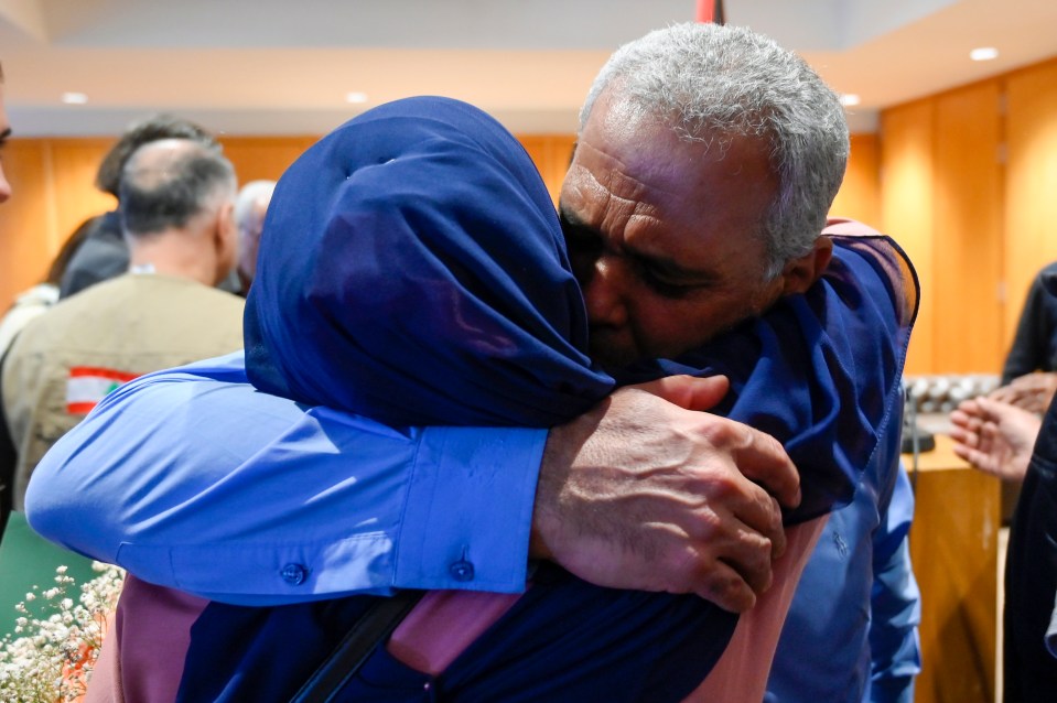 An evacuee is embraced after disembarking from a Lebanese evacuation flight