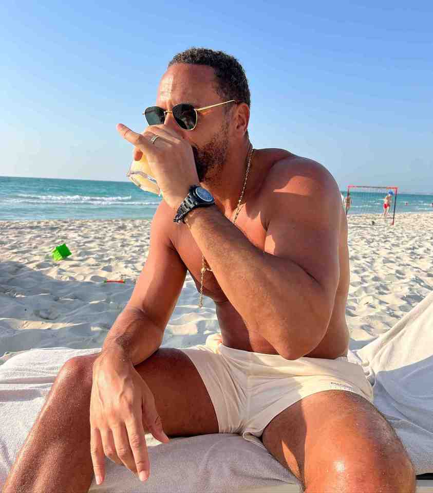 Former footballer Rio, 44, soaked in the sunshine on the beach in white shorts