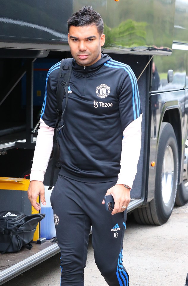 Fellow midfielder Casemiro smiles for the camera as he boards the coach