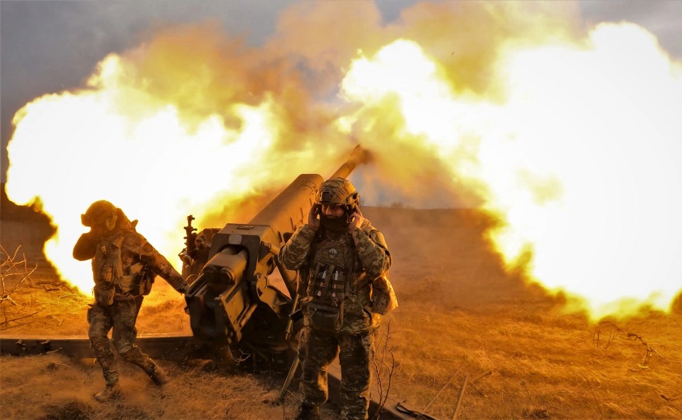 Ukrainian servicemen fire with a D-30 howitzer at Russian positions near Bakhmut