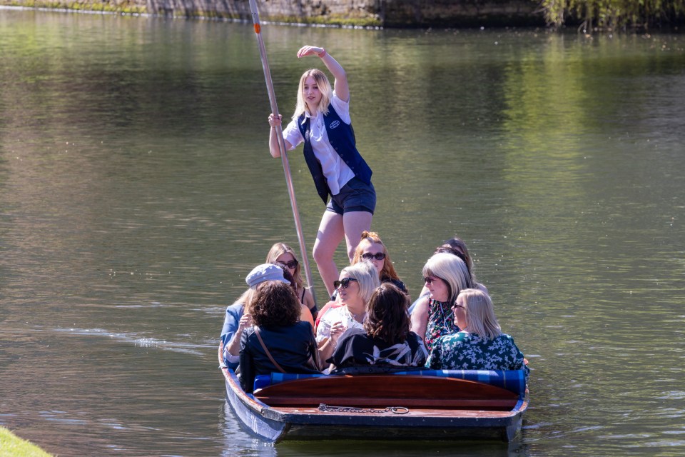 People make the most of the sunny weather with a punt on the River Cam in Cambridge