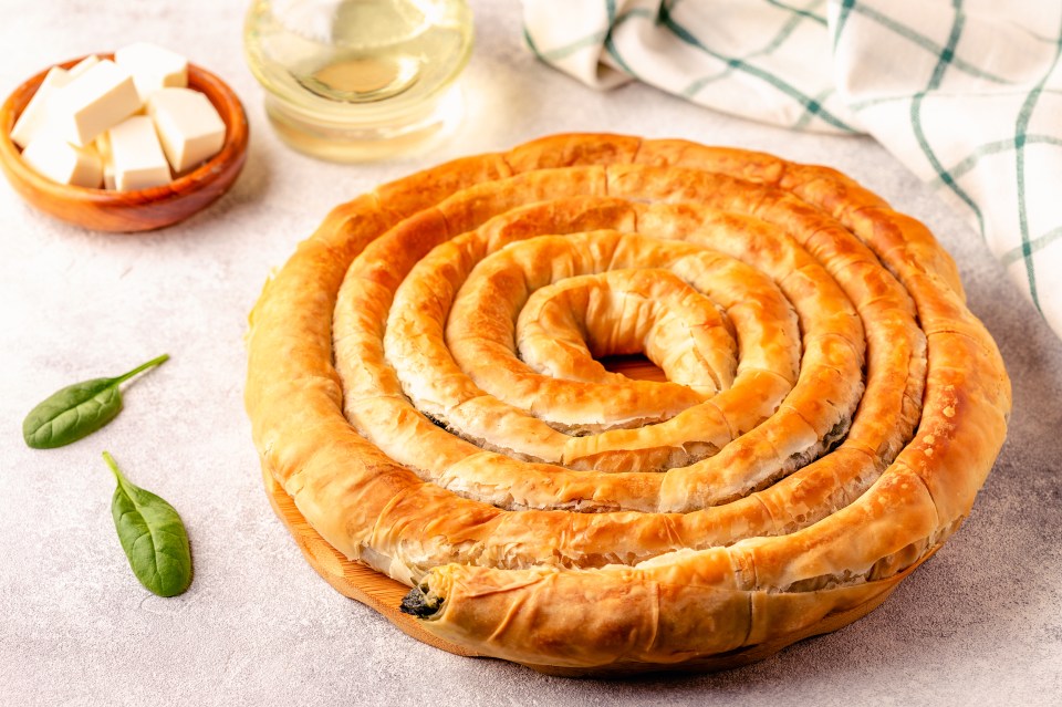 Tyropita is a spiral-shaped feta cheese pie in filo pastry that’s a local delicacy