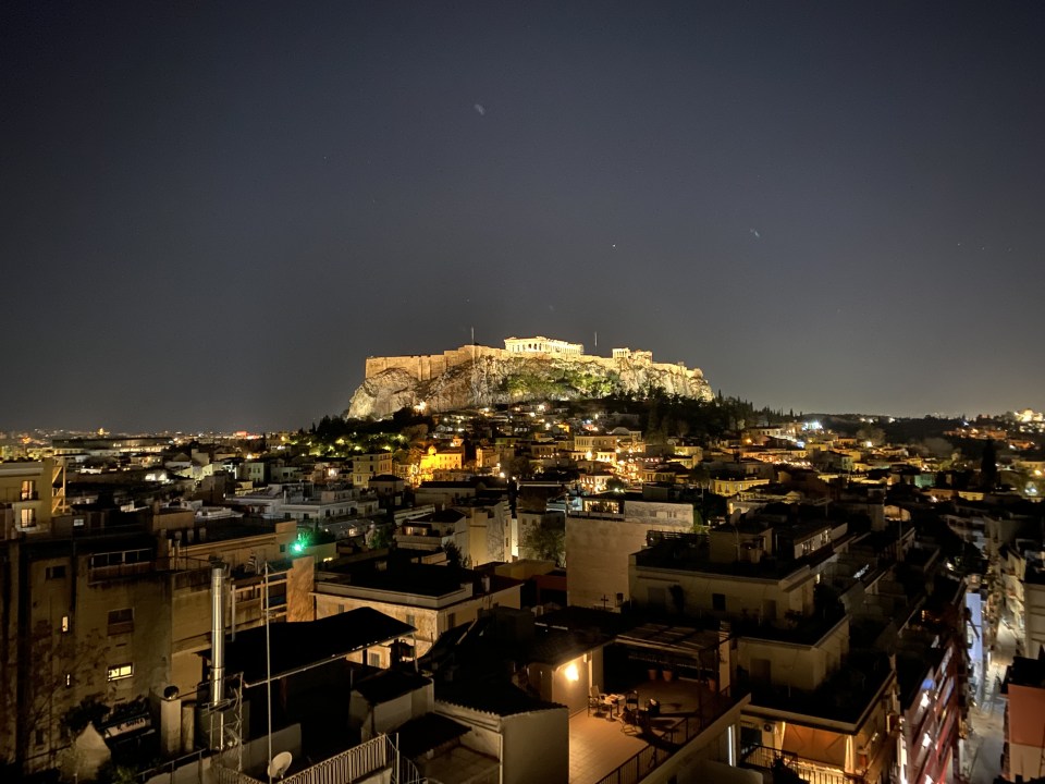 The Parthenon illuminated at night provides a stunning backdrop for dinner