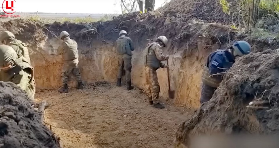 Hired labourers are digging a giant gash across the countryside