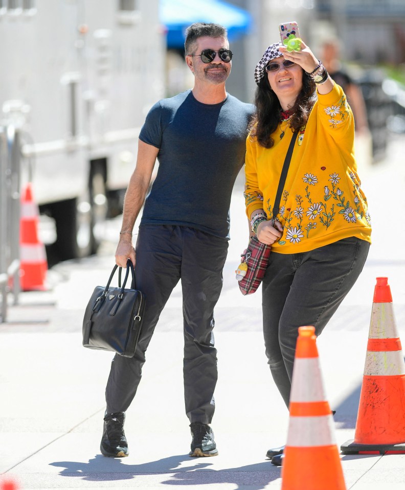 Simon Cowell posed with an eager fan as he headed to a busy day of filming