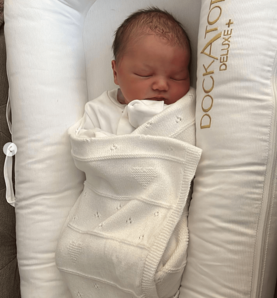 The star shared first photos of her daughter wrapped in a blanket