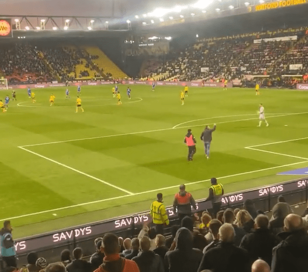 The fan invaded the pitch and began gesticulating towards the players