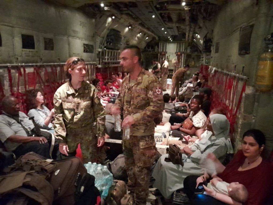 Italian citizens on an Air Force transport plane after being evacuated from Khartoum today