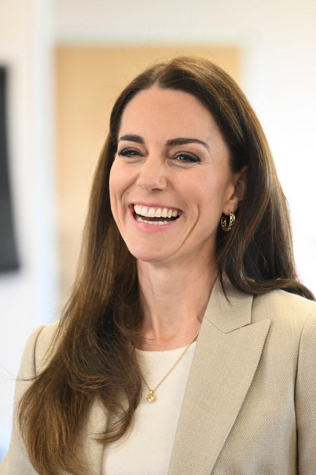 A beaming Kate at the baby clothes charity