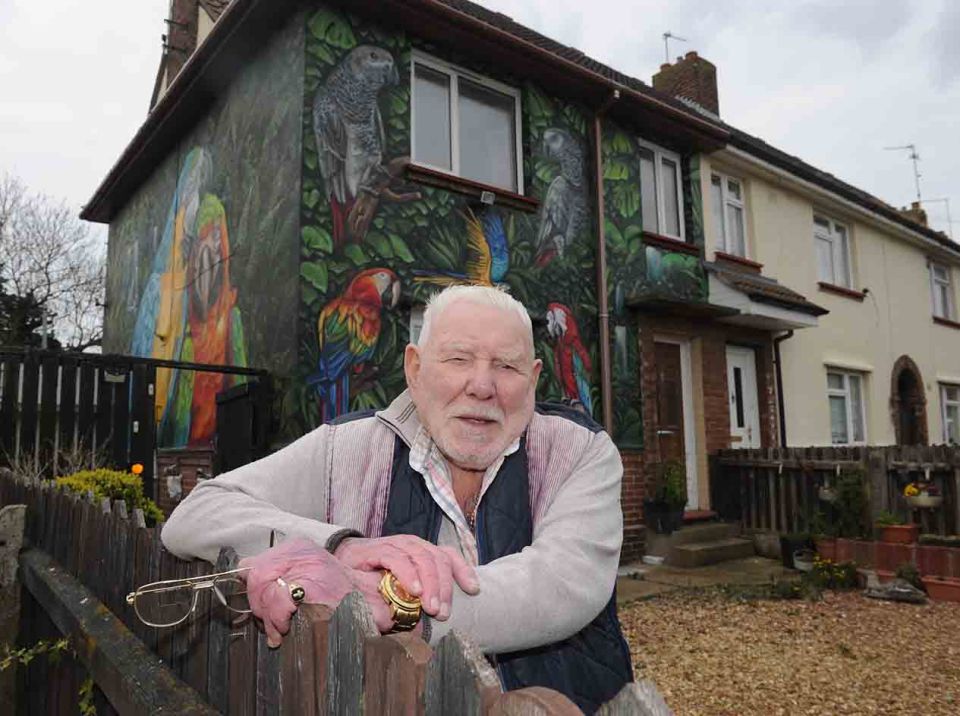 Gordon Squires, 92, in front of the giant parrot mural