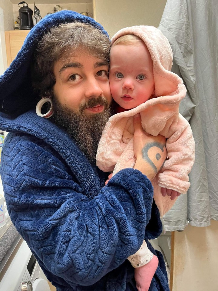 Dad Samuel Penny, 21, holds little Melanie, who at one is now thriving