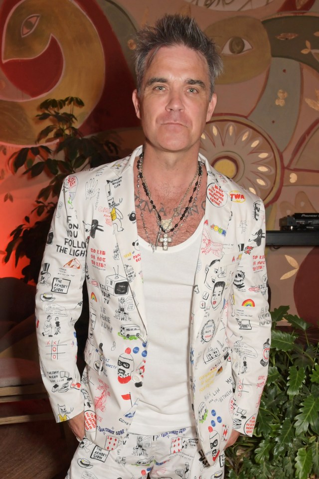 IBIZA, SPAIN - AUGUST 16: Robbie Williams attends the TCA Ibizan Art Gala 2022 hosted by Darren Strowger and Robbie Furze in aid of Teen Cancer America (TCA) and Ibiza and Formentera Against Cancer (IFCC) at Six Senses Ibiza on August 16, 2022 in Ibiza, Spain. (Photo by David M. Benett/Dave Benett/Getty Images)