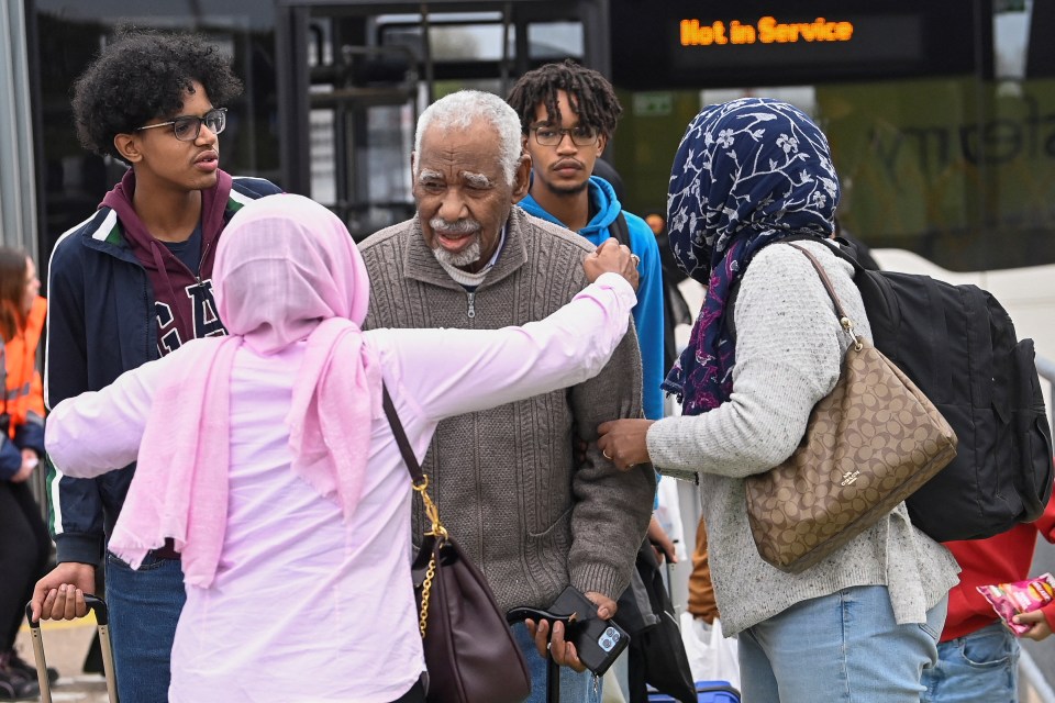 An evacuee arrives back in the UK from Sudan at Stansted