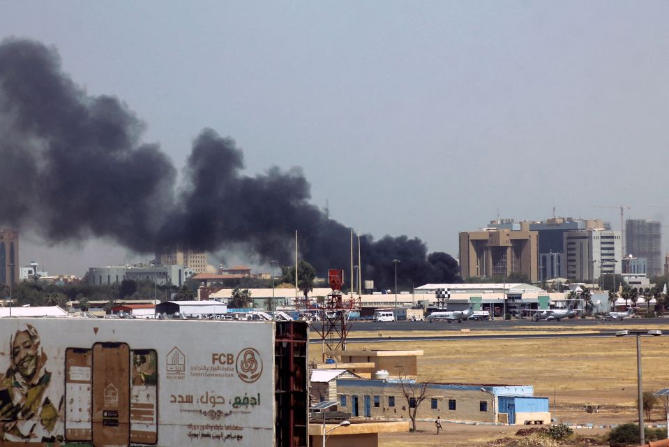 Heavy smoke bellows above buildings in the vicinity of the Khartoum airport on April 15