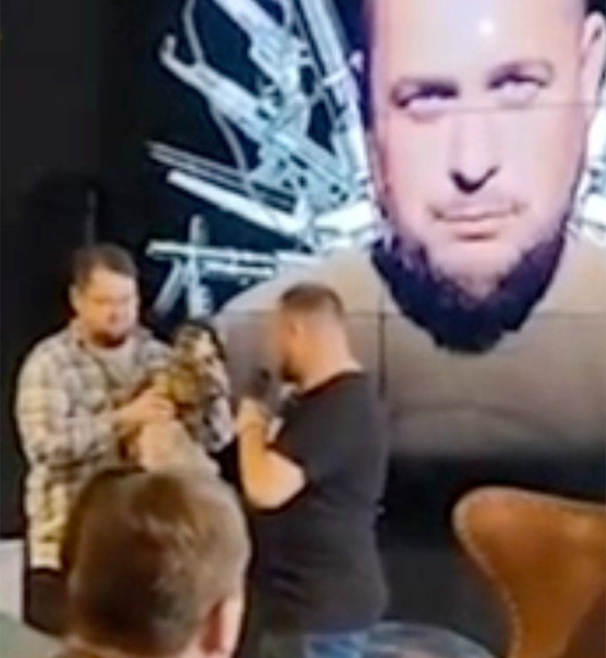 Tatarsky is caught inspecting the golden figurine presented by an unknown woman