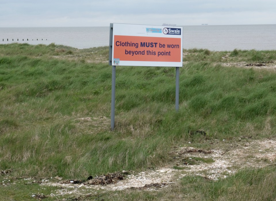 A sign warns nudists they must put clothes on before leaving the beach