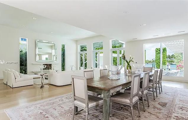 Photos show a bright, spacious living room with glass coffee tables