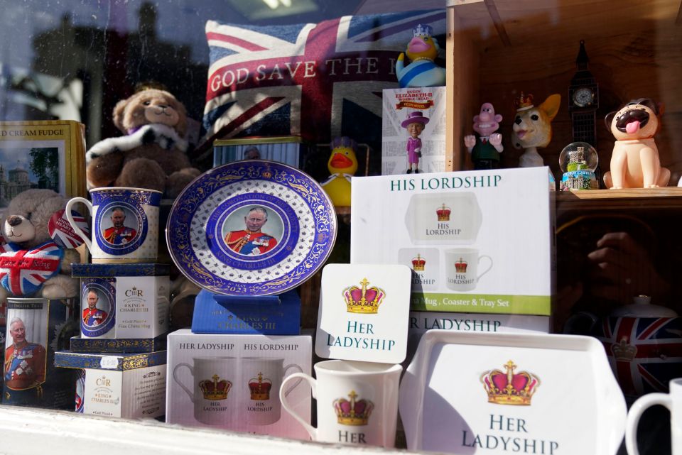 Coronation merchandise displayed in a shop window near Windsor Castle, Berkshire