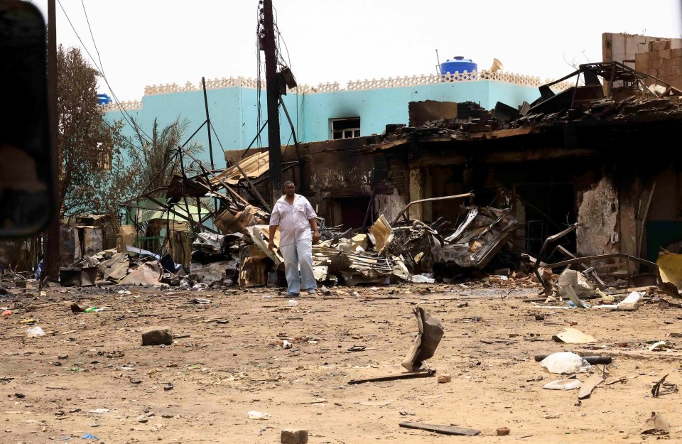 A man walks among the charred rubble