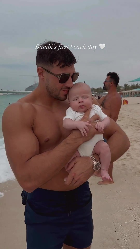 Doting dad Tommy cradled Bambi on the beach