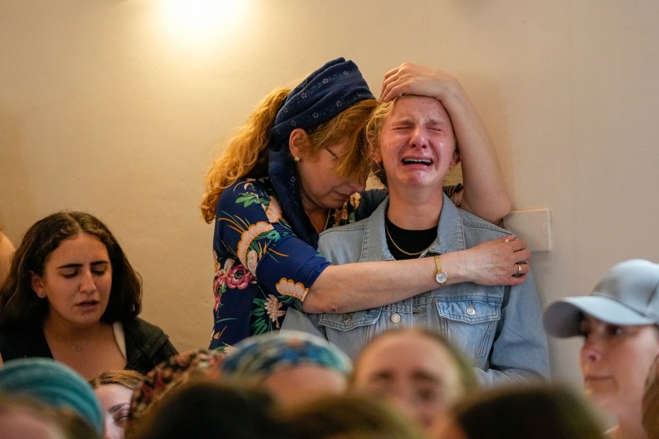 Mourners at the funeral of two British-Israeli sisters