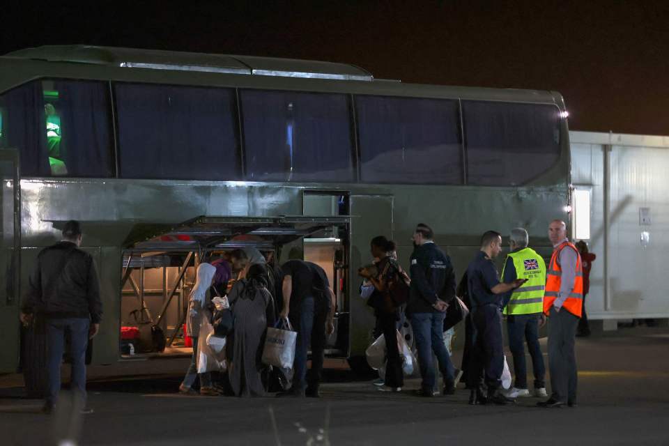 The newly-rescued British citizens board a bus - finally safe from the terror of war