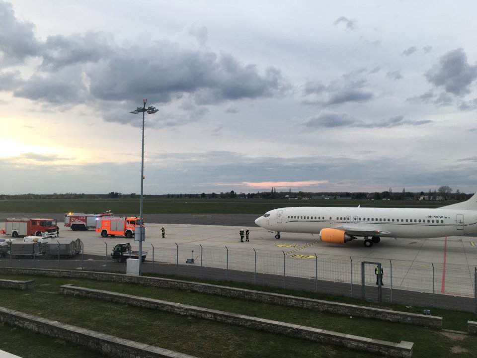 Firefighters scramble to the aircraft after the engine inferno