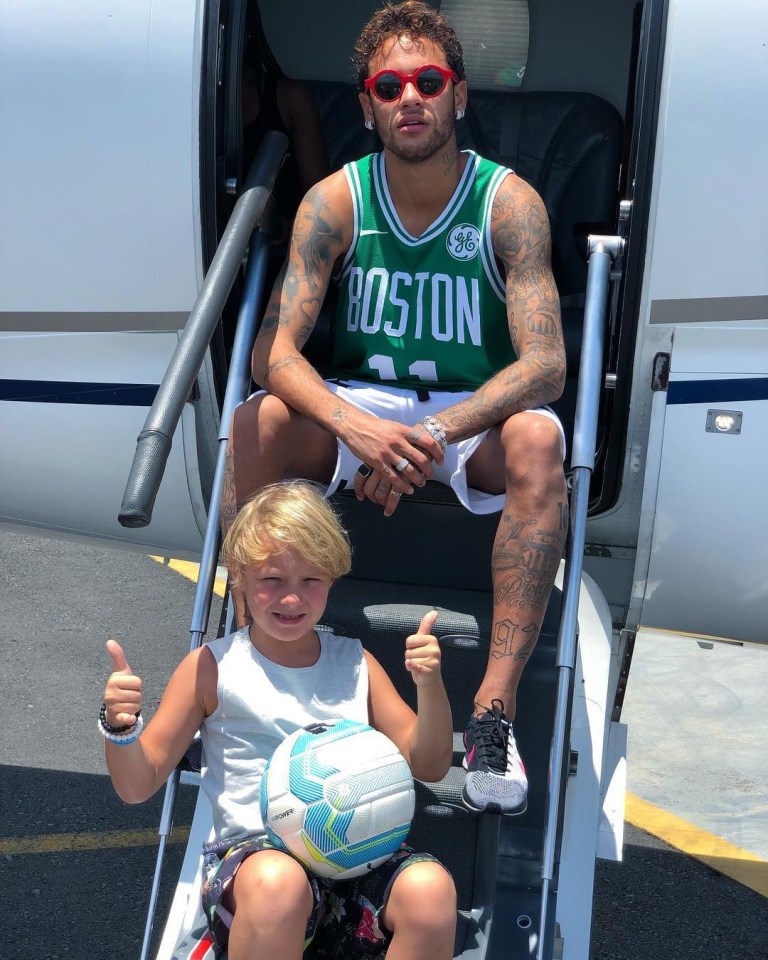 Son Davi Lucca, 11, poses on the steps of dad's luxury private jet