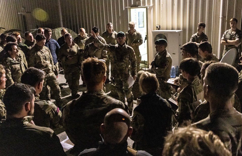 Marines from 40 Commando receive a brief before heading to Sudan