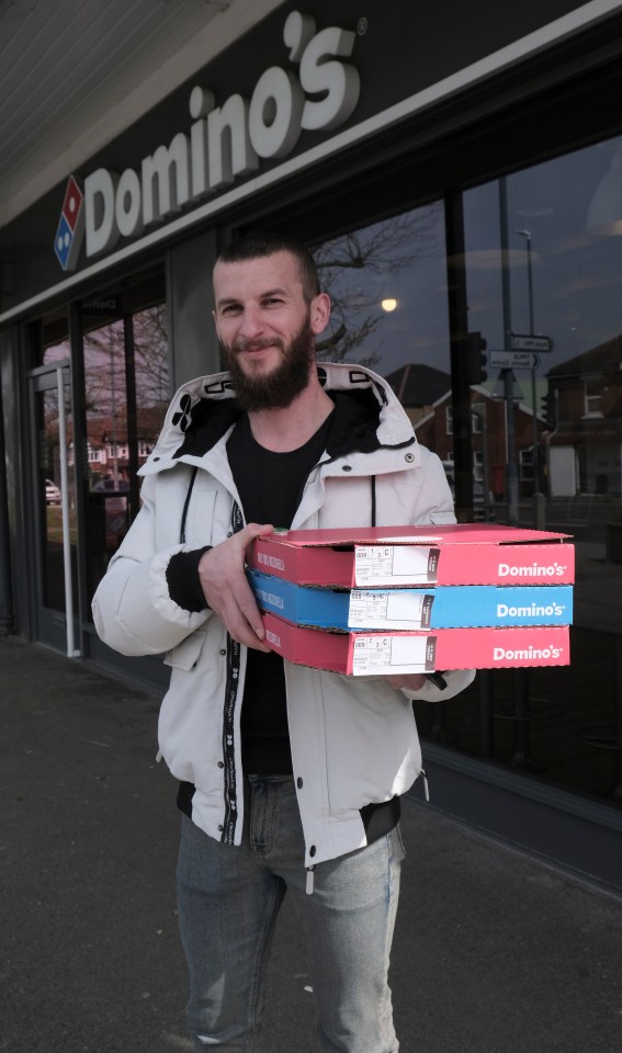 Dan Toadr, 29, who lives nearby, carrying his pizza haul outside the roomy restaurant