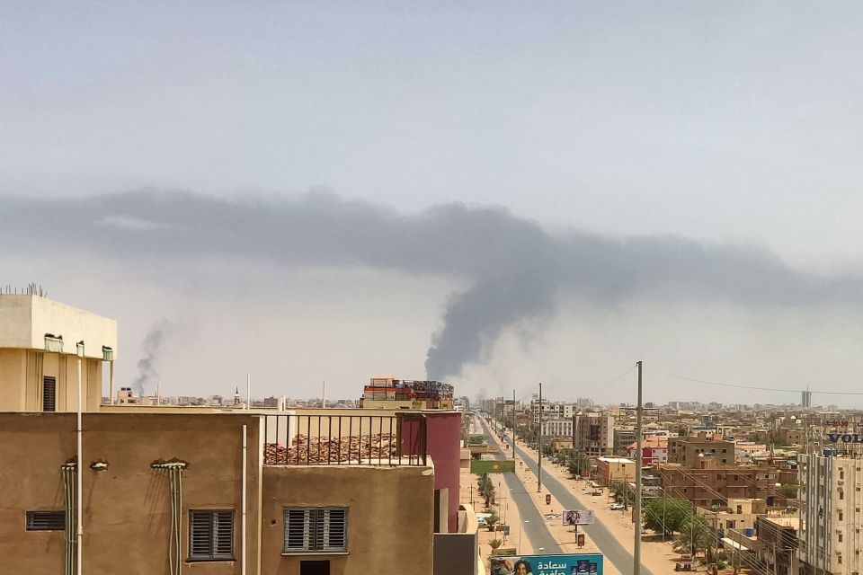 Plumes of smoke rise on the horizon in an area east of Khartoum