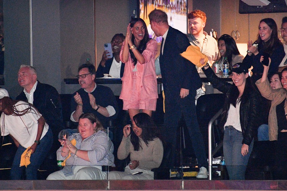 Meghan and Harry in a luxury box with some of their entourage