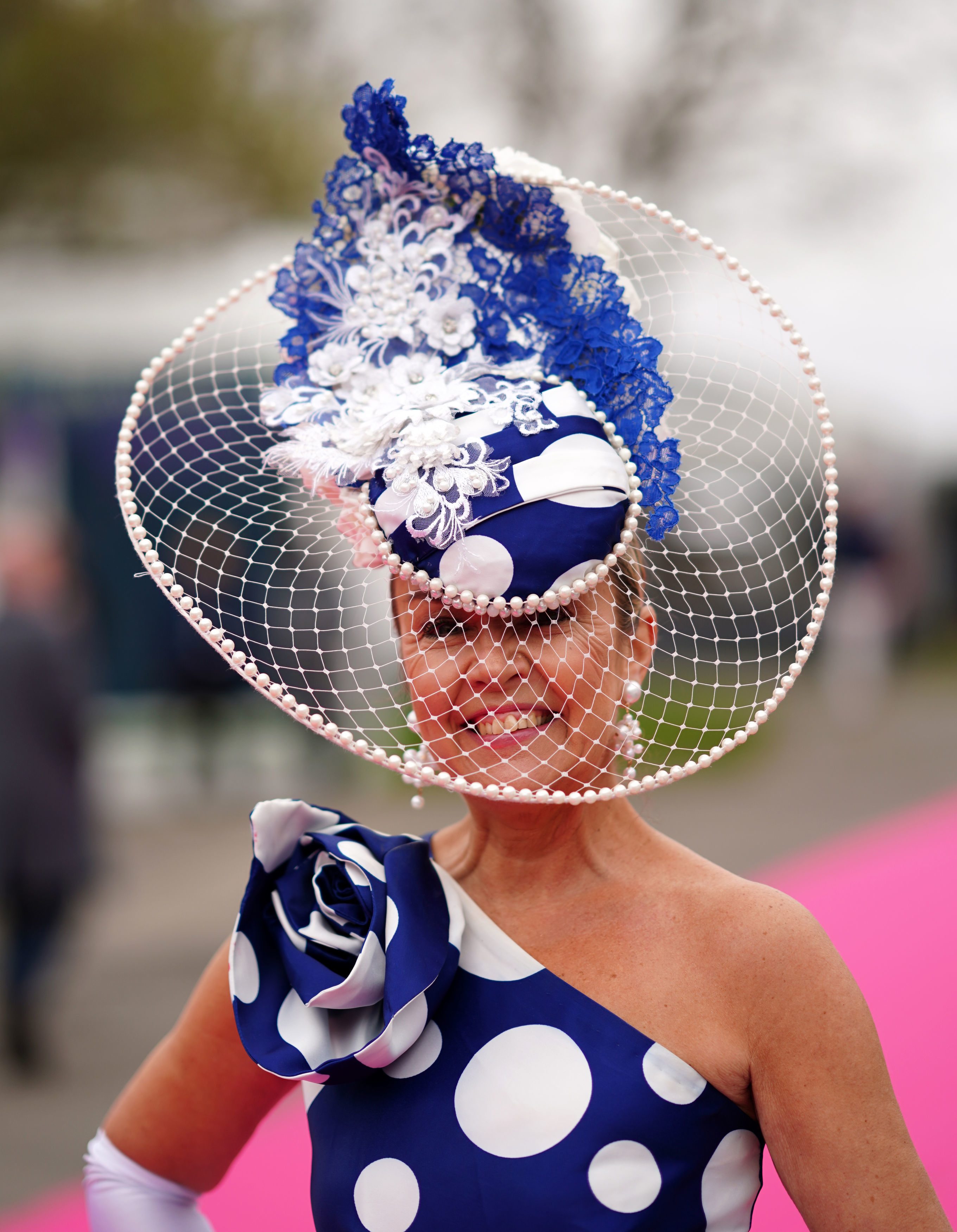 This elegant racegoer was dressed to the nines in an extravagant blue and white gown and matching headpiece