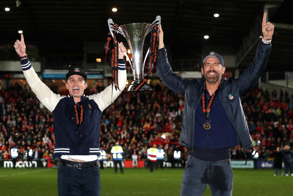 Rob McElhenney and Ryan Reynolds celebrate with the Vanarama National League trophy over the weekend