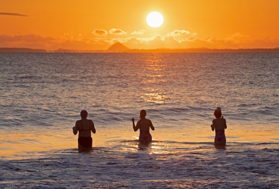 Swimmers brave nippy waters at sunrise in the Firth of Forth, Scotland