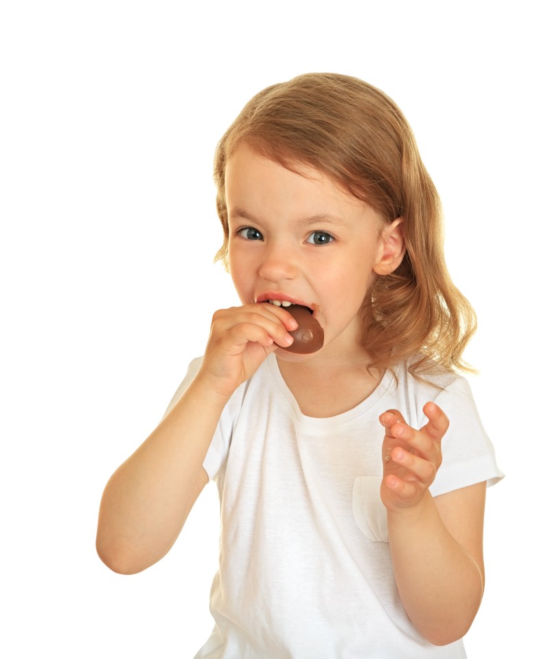 A little girl eating a delicious chocolate.; Shutterstock ID 57344608; purchase_order: -; job: -; client: -; other: -