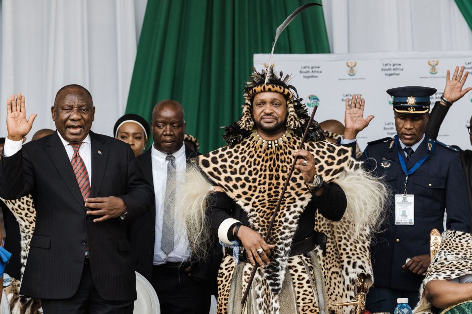 South African President Cyril Ramaphosa raises his hand next to King Misuzulu Zulu