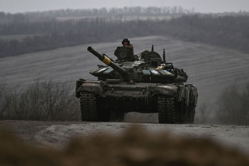 A Ukrainian army tank rolls one of the last roads going into Bakhmut