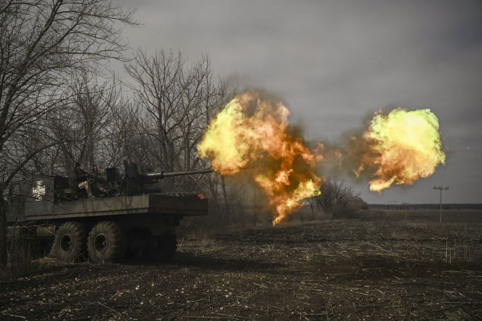 Ukrainian servicemen fire with a S60 anti-aircraft gun near Bakhmut