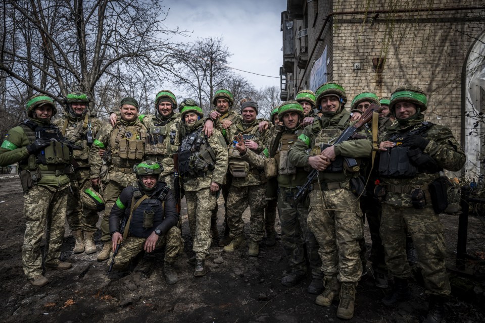 Ukrainian soldiers pose on the frontline of Donetsk Oblast