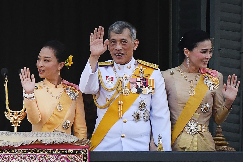 Thailand’s King Maha Vajiralongkorn (centre) waves to well-wishers from the balcony of Suddhaisavarya Prasad Hall of the Grand Palace on the final day of his royal coronation in Bangkok