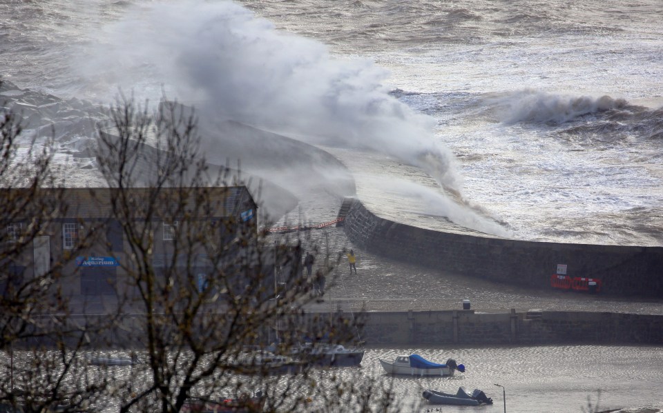 Huge waves crash into the seafront at Lyme Regis, Dorset, today