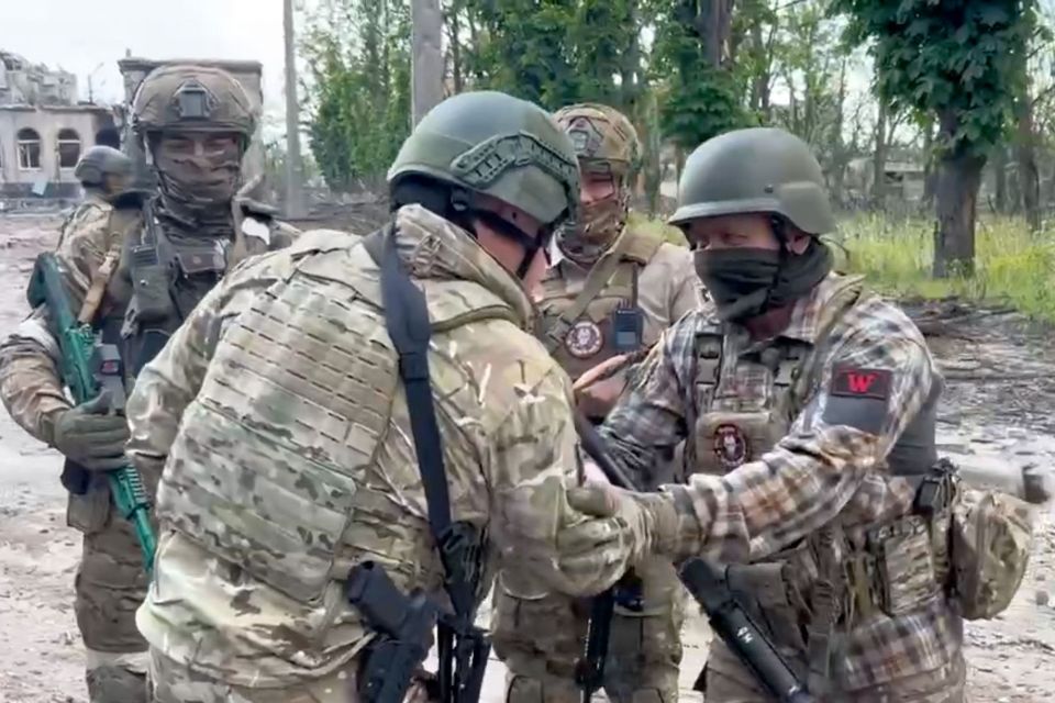 The warlord is seen congratulating his mercenary soldiers on 'taking the city'