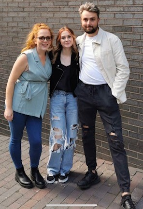 Filming took place in May last year and they chose 22-year-old Lizzie, pictured in the middle, who had never been part of throuple