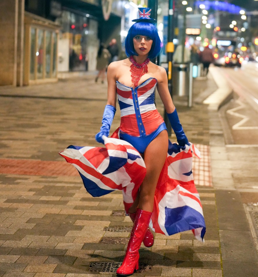 A woman wears a PVC Union Jack outfit while out on the town in Birmingham