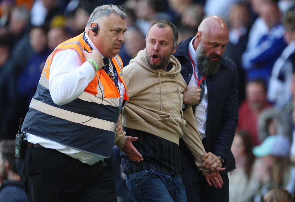 The Leeds fan appeared to remain aggravated as he was led away from the scene