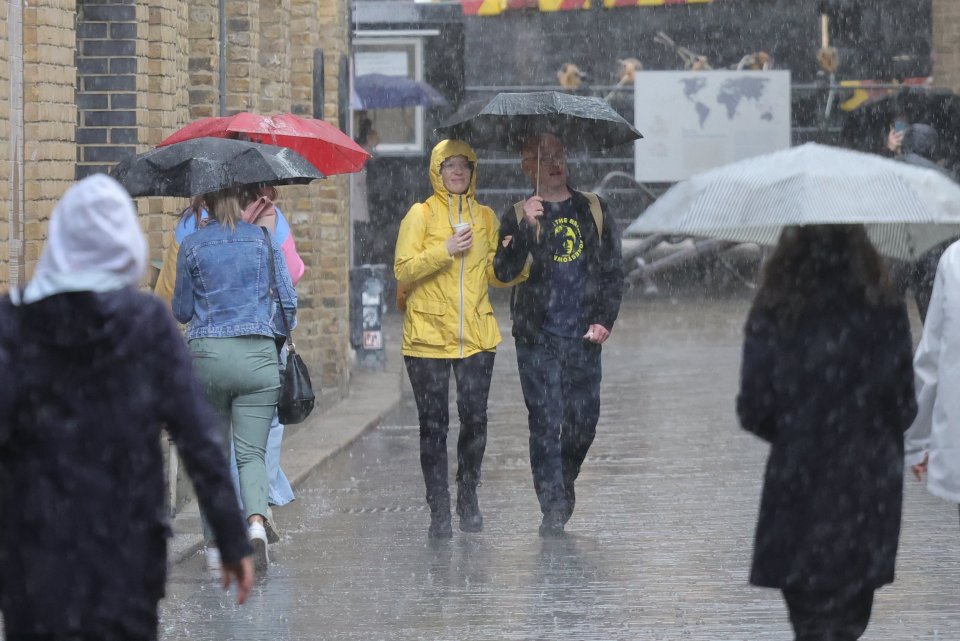 Londoners get a drenching at London Bridge as the rain closes in on the capital